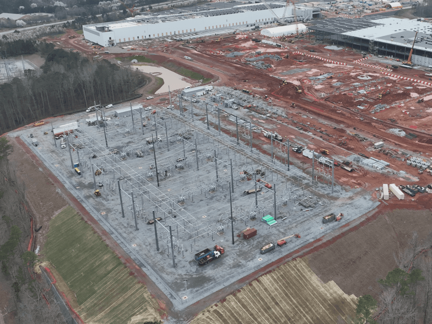 Construction inspector documenting site progress with tablet